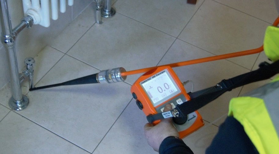 Man using a water leak detector